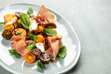 prosciutto salad, cherry tomatoes, and cream cheese with basil leaves, antipasto, Restaurant menu, dieting, cookbook recipe top view
