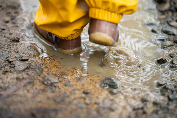 baby in puddle in a park