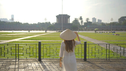 Portrait of Asian Vietnamese woman with Vietnam dress and straw hat travel at Ho Chi Minh...
