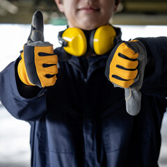 Pros and cons concept. Construction worker man with uniform suit, ear muffs and protective gloves...