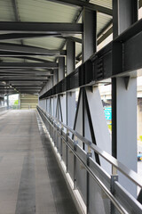 Pedestrian pathway or corridor or hallway between train station and building.