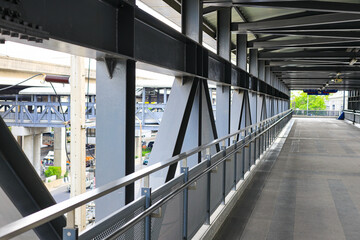 Pedestrian pathway or corridor or hallway between train station and building.