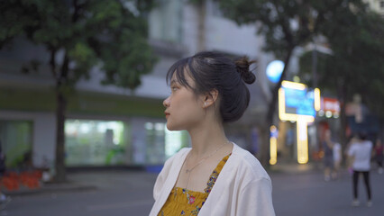 Fototapeta premium Asian Vietnamese woman walking on the street in Hanoi urban city town, Vietnam.