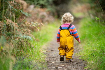 toddler walking on a hike in a park