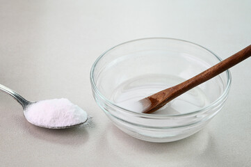 Mixing baking soda with water in a glass bowl