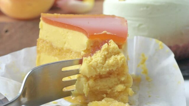 piece of mango mousse cake with fork