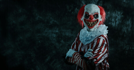 mad cross-armed redhead clown on a dark background