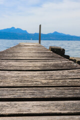 Fototapeta premium Wooden pier overlooking the Alps and Lake Geneva in Switzerland
