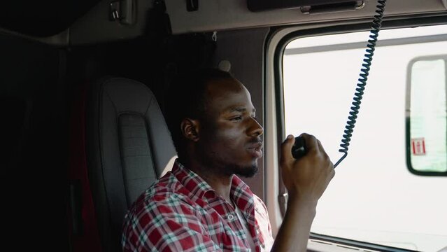 African American Truck Driver Making Talking Through Radio. Semi Truck