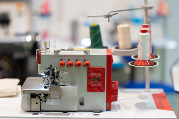 Spools of threads are connected to an embroidery machine