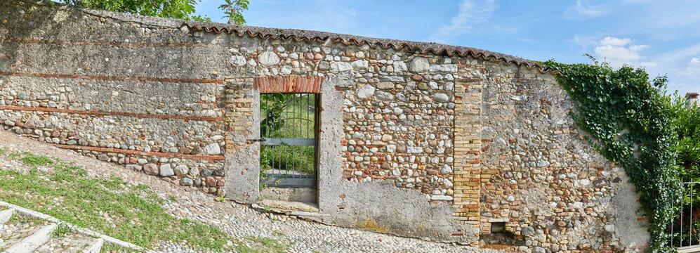 Rustic castle wall in Tuscany, in panoramic format, 
