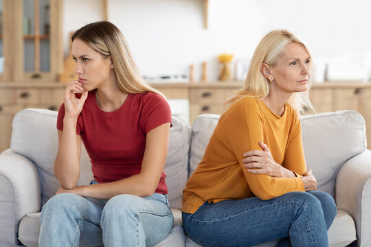 Offended millennial adult daughter and senior mother sit aside