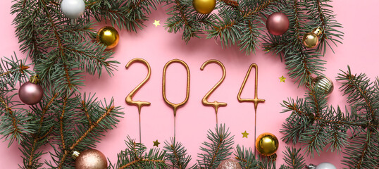 Figure 2024, with Christmas balls and fir branches on pink background