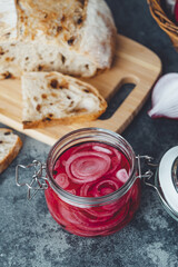 Pickled red onions with slices of homemade bread. Healthy organic food. top view.