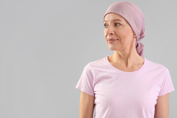 Mature woman after chemotherapy on grey background
