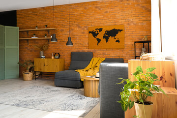 Interior of stylish living room with cozy armchairs near brick wall