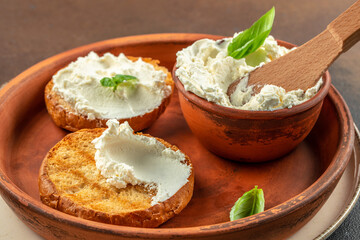 Sandwiches with tasty cream cheese and fresh basil leaves. Food recipe background. Close up