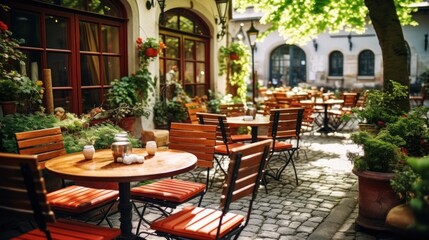 Tables and chairs of outdoor cafe in european city. - obrazy, fototapety, plakaty