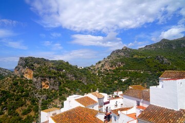 view over the roofs of the mountain village Casares with typical white houses in Andalusia and...