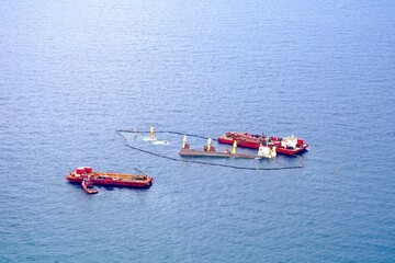 sunk cargo ship after collision with a tanker near Gibraltar, shipwreck, oil boom, environmental...