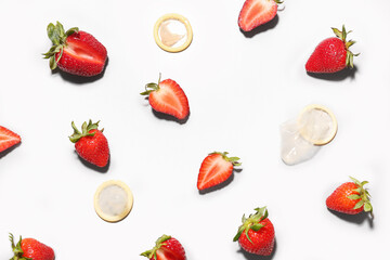 Strawberries with condoms on light background. Sex concept