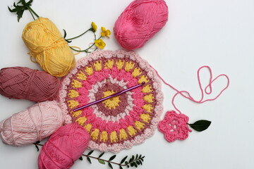 Pink crocheting. Handmade ornament made of organic pink yarn. White background with copy space....