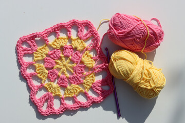 Pink crocheting. Handmade ornament made of organic pink yarn. White background with copy space....