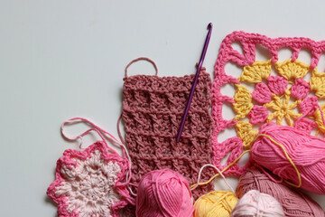 Different crocheted elements on white background with copy space. Handmade home decoration....
