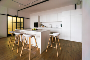 Gourmet kitchen features white shaker cabinets with marble countertops, stone subway tile backsplash, double door stainless steel refrigerator and gorgeous kitchen island.