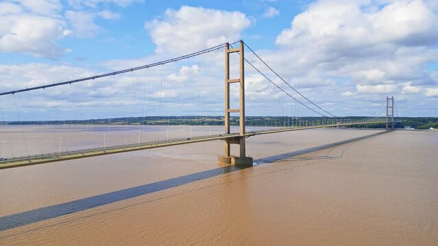 Aerial drone view of Humber Bridge, 12th largest suspension span, gracefully crossing River Humber, connecting Lincolnshire to Humberside with traffic.
