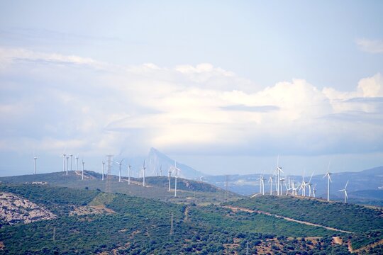 many wind turbines in the mountains of Andalusia, Spain, Rock of Gibraltar in the background, sustainability, wind farm, energy source, electricity, energy, power, wind, environment