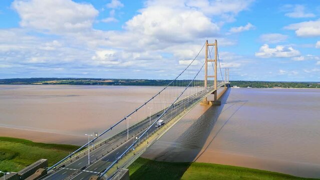Aerial drone view of Humber Bridge, 12th largest suspension span, gracefully crossing River Humber, connecting Lincolnshire to Humberside with traffic.