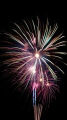 Fototapeta premium Red and golden fireworks over the river, sea, ocean in the night sky. Explosion of light, happiness, beauty of the moment.