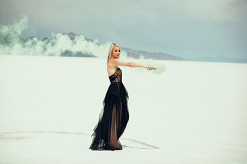 Beautiful blonde woman in a black dress at the Utah Salt Flats