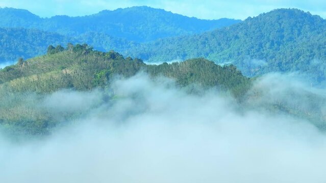 Drone glides gracefully through the air, it captures the delicate dance between the fog and the landscape. as if time itself has slowed down to allow nature's beauty to take center stage. Thailand.
