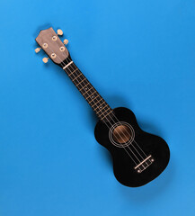 Fototapeta premium black ukulele isolated on black background