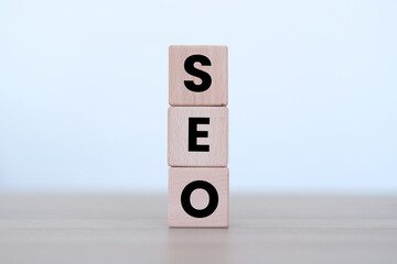 SEO word on block cubes lined vertically, website or search engine optimization idea, wooden block...