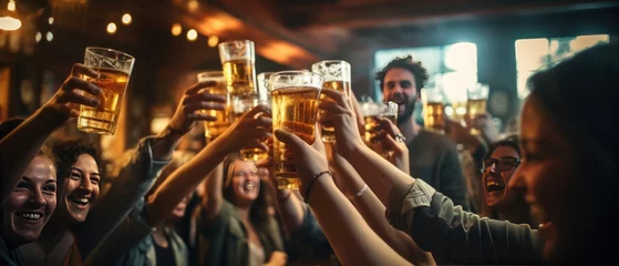 Fotobehang Group of friends clinking glasses of beer at bar or pub. © John Martin