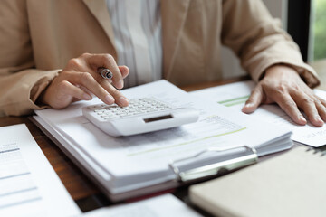 Woman Analysis Business Accounting working with&nbsp;Individual income tax return Accounting concept..