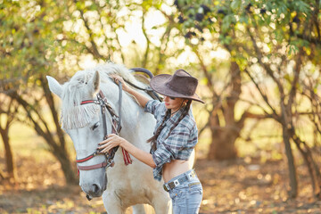 Portrait of young cowgirl and horse