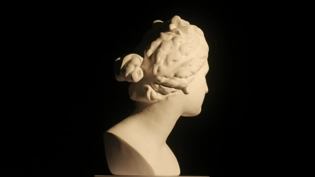 Closeup shot. Ancient marble bust statue of roman era woman spinning round on a platform. Isolated on black background. HDR BT2020 HLG Material.