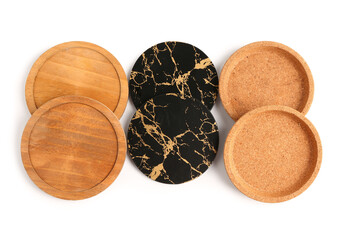 Set of table coasters and plates on white background