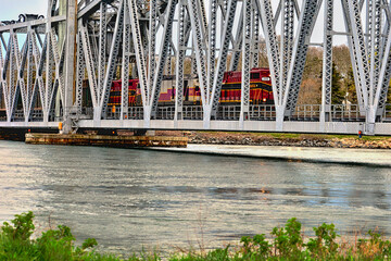 The vertical lift rail road bridge spanning the cape cod canal in the lowered position with a train...