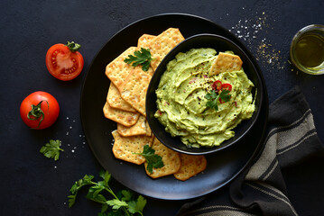 Guacamole - traditional mexican spicy avocado dip. Top view with copy space.