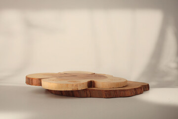 Wooden eco rustic pine tree circle disc platform podium on beige light and shadow copy spase...