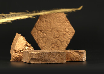 Bronze stone platform podium and gold leaf on black background. Minimal empty display product presentation scene.