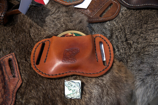 A metal stamp on a furry background is what was used to create the design on the final leather product .