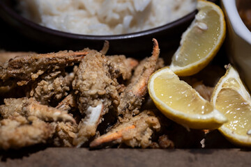Fried crab fingers with lemon slices.