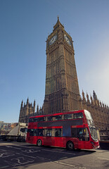 Fototapeta na wymiar London. Beautiful sky colors over Westminster and background the Big Ben with Double Decker bus crossing the bridge.