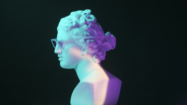 Closeup shot. Ancient marble bust statue of roman era woman in glasses spinning round on a platform in blue neon light. Isolated on black background. HDR BT2020 HLG Material.